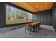 Covered patio with wooden table, chairs, and wooded outdoor view at 2497 Wawona Ne Dr, Brookhaven, GA 30319