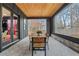 Covered patio with dining table, wood ceiling, and view of trees at 2497 Wawona Ne Dr, Brookhaven, GA 30319