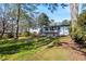 Backyard features a sunroom addition and large trees perfect for outdoor enjoyment at 2519 Lauderdale Ne Dr, Atlanta, GA 30345