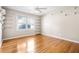 Bedroom featuring hardwood floors, natural light, a ceiling fan, and shelving for decor and storage at 2519 Lauderdale Ne Dr, Atlanta, GA 30345