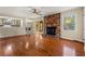Bright living room boasts hardwood floors, brick fireplace, and access to sunroom at 2519 Lauderdale Ne Dr, Atlanta, GA 30345