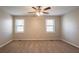 Large bedroom with neutral walls, carpet, and two windows for natural light at 6265 Stoney Cv, Austell, GA 30168