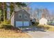 Side view of a charming home, highlighting its architectural details and garage at 6265 Stoney Cv, Austell, GA 30168