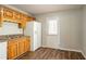 Functional kitchen with white refrigerator, wooden cabinets, and backyard access at 6265 Stoney Cv, Austell, GA 30168