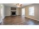 Cozy living room with hardwood floors, a stone fireplace, and large windows at 6265 Stoney Cv, Austell, GA 30168