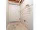 Functional utility room with concrete floors and wall-mounted shelving at 6265 Stoney Cv, Austell, GA 30168