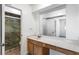 Bathroom featuring a marble shower, large mirror, and vanity at 838 Lake Hollow Sw Blvd, Marietta, GA 30064
