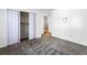 Clean bedroom featuring neutral carpet, a closet with folding doors, and ample natural light at 838 Lake Hollow Sw Blvd, Marietta, GA 30064