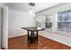 Dining room boasts beautiful wood floors, a modern chandelier, and natural light from large windows at 838 Lake Hollow Sw Blvd, Marietta, GA 30064