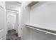 Hallway view features gray carpet and a bright closet with built-in shelving and organizers at 838 Lake Hollow Sw Blvd, Marietta, GA 30064