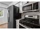 Kitchen features modern appliances including a black refrigerator and a black gas range oven at 838 Lake Hollow Sw Blvd, Marietta, GA 30064