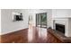 Bright living room with fireplace, wood floors, sliding glass door, and bar access to kitchen at 838 Lake Hollow Sw Blvd, Marietta, GA 30064