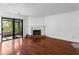 Bright living room featuring a fireplace, sliding glass door, and beautiful wood flooring at 838 Lake Hollow Sw Blvd, Marietta, GA 30064