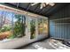 Enclosed back patio with an airy atmosphere and outdoor access through glass windows and doors at 838 Lake Hollow Sw Blvd, Marietta, GA 30064
