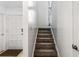 Staircase leads to the second floor with a high window for natural lighting at 838 Lake Hollow Sw Blvd, Marietta, GA 30064