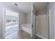 Bathroom showcasing tiled floor, large tub, and separate glass shower at 2873 Snapfinger Mnr, Decatur, GA 30035