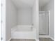 Well-lit bathroom showcasing large tub and glass-enclosed shower at 2873 Snapfinger Mnr, Decatur, GA 30035