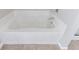 Clean bathroom with white tub and tile flooring at 2873 Snapfinger Mnr, Decatur, GA 30035