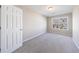 Neutral bedroom with a window, carpeting, and white trim at 2873 Snapfinger Mnr, Decatur, GA 30035