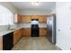 Functional kitchen with stainless steel refrigerator, tile flooring, and ample cabinet storage at 2873 Snapfinger Mnr, Decatur, GA 30035