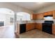 Open kitchen with tile floors, wood cabinetry, and a seamless transition to the adjacent living room at 2873 Snapfinger Mnr, Decatur, GA 30035