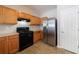 Efficient kitchen layout with stainless steel fridge, and black gas range, plus tile floor at 2873 Snapfinger Mnr, Decatur, GA 30035