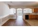 Open-concept kitchen featuring hardwood floors, wood cabinets, and seamless flow into the living spaces at 2873 Snapfinger Mnr, Decatur, GA 30035