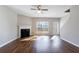 This living room has wood floors, a fireplace, a ceiling fan, and a door to the backyard at 2873 Snapfinger Mnr, Decatur, GA 30035