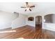 Living room boasts ceiling fan, stairs, hardwood floors, and seamless access to the kitchen at 2873 Snapfinger Mnr, Decatur, GA 30035