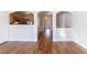 Open concept living room with views into the kitchen, nice hardwood floors, and arched doorways at 2873 Snapfinger Mnr, Decatur, GA 30035