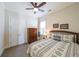 Cozy bedroom featuring a ceiling fan, patterned bedding, and natural light from the window at 307 Serenity Way, Woodstock, GA 30188