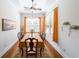 Elegant dining room featuring a wooden table, decorative window treatments, and ample natural light at 307 Serenity Way, Woodstock, GA 30188