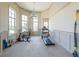 Bright exercise room features large windows, neutral paint, and carpeted floors with multiple exercise machines at 307 Serenity Way, Woodstock, GA 30188