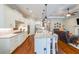 Bright, white kitchen with stainless steel appliances, a large island with seating, and hardwood floors at 307 Serenity Way, Woodstock, GA 30188