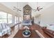 Large community living room with soaring fireplace, hardwood floors, and plenty of seating at 307 Serenity Way, Woodstock, GA 30188
