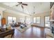 Spacious living room with fireplace, hardwood flooring, and natural light from the surrounding windows at 307 Serenity Way, Woodstock, GA 30188