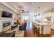 Open-concept living space with a kitchen island, seamless transition into living room with a fireplace at 307 Serenity Way, Woodstock, GA 30188