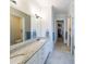 Elegant bathroom with double sinks, granite countertops, and tile flooring at 307 Serenity Way, Woodstock, GA 30188