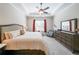 Spacious main bedroom with a ceiling fan, tray ceiling, and large window at 307 Serenity Way, Woodstock, GA 30188
