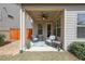 Covered patio with comfortable seating, perfect for relaxing outdoors at 307 Serenity Way, Woodstock, GA 30188