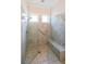 Tiled shower with glass door, bench, and adjustable shower head at 307 Serenity Way, Woodstock, GA 30188