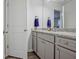 Stylish bathroom featuring gray cabinets, granite counters, and a framed mirror at 370 Cassidy Trl, Douglasville, GA 30134