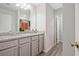 Bathroom features a granite countertop vanity with double sinks and modern wood-look flooring at 370 Cassidy Trl, Douglasville, GA 30134