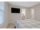 Spacious bedroom featuring a queen-size bed with a flat screen TV and an open door to the bathroom at 370 Cassidy Trl, Douglasville, GA 30134