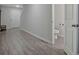 Hallway with wood-look floors leading to the front door and a view of a powder room at 370 Cassidy Trl, Douglasville, GA 30134