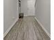 Hallway with wood-look floors leading to a white paneled door and a coat rack at 370 Cassidy Trl, Douglasville, GA 30134