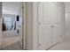 Hallway with neutral walls, carpet floor, white doors and leads to the bedroom area at 370 Cassidy Trl, Douglasville, GA 30134