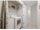 Bright laundry room features modern appliances and ample shelf storage for convenience at 370 Cassidy Trl, Douglasville, GA 30134