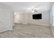 Living room featuring modern flooring, neutral paint, and large television at 370 Cassidy Trl, Douglasville, GA 30134