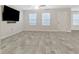 Bright living room with neutral paint, ceiling fan, and modern gray flooring throughout at 370 Cassidy Trl, Douglasville, GA 30134